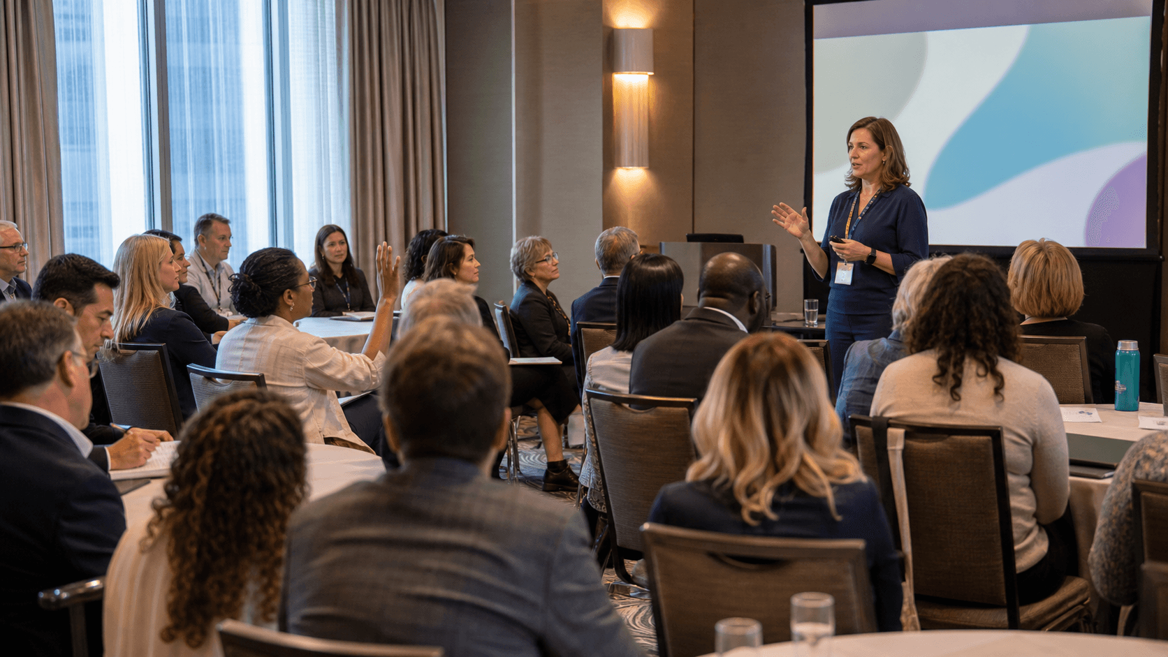Pharmacy professionals listening to a presenter at a professional meeting