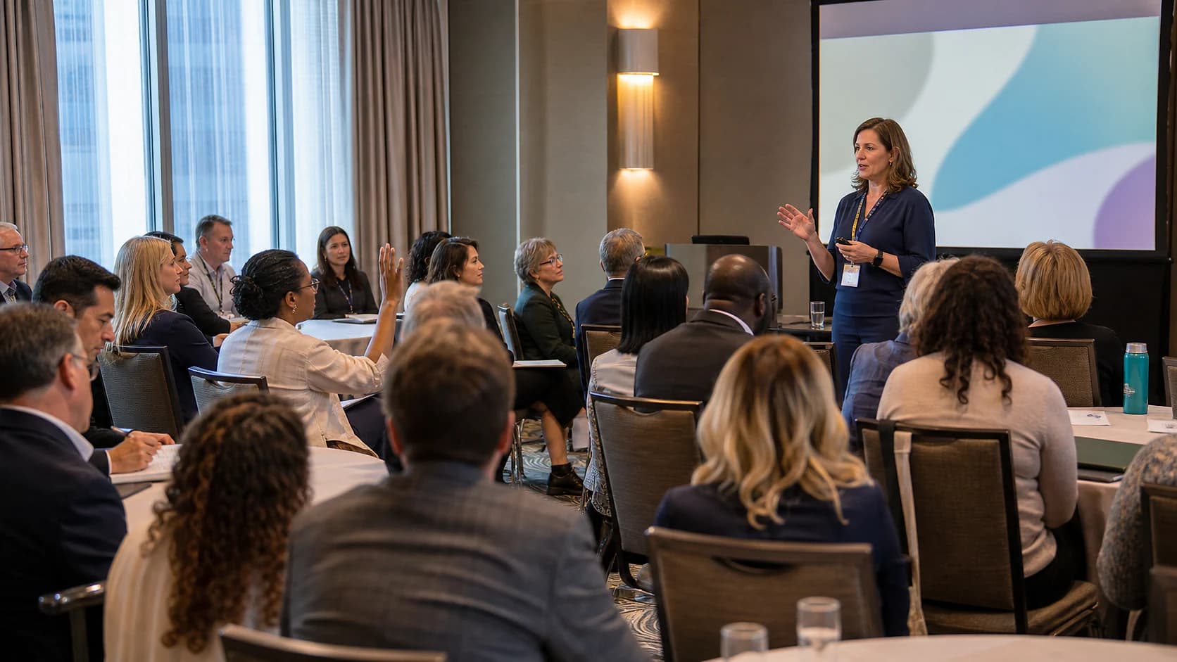 Pharmacy professionals listening to a presenter at a professional meeting